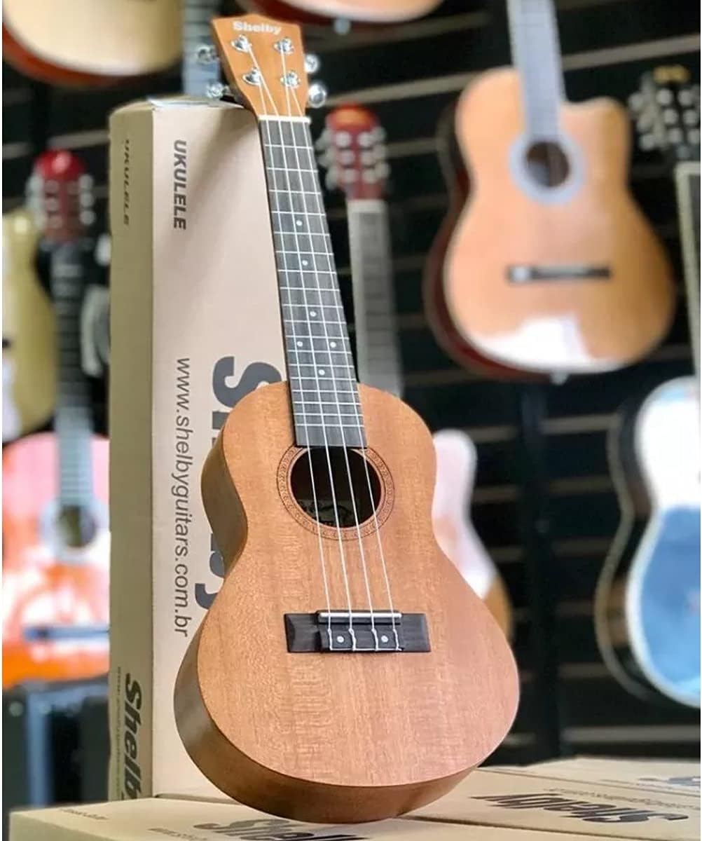 Ukulele acústico Shelby SU23M Concerto em mogno com caixa da marca e fundo de loja de instrumentos musicais