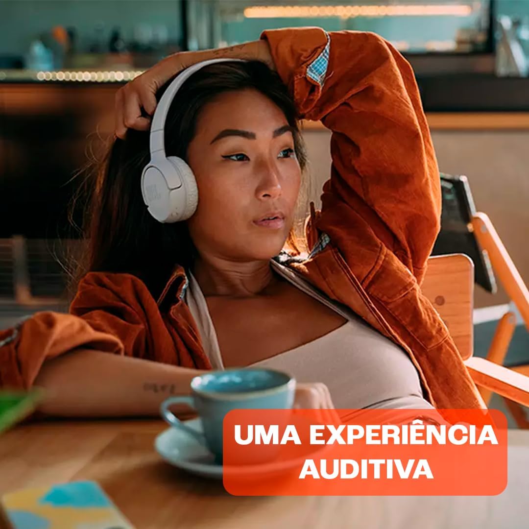 Mulher usando fones JBL Tune 520BT brancos proporcionando uma experiência auditiva de qualidade.
