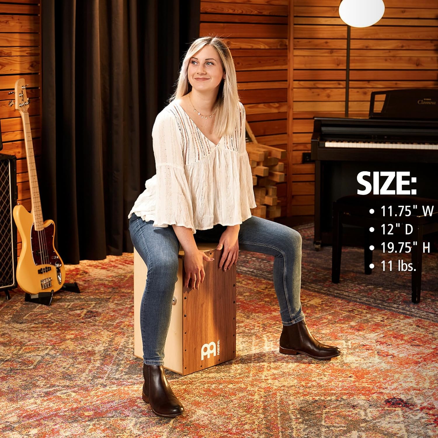 Dimensões do cajon Meinl Snarecraft Professional com mulher tocando em ambiente interno.