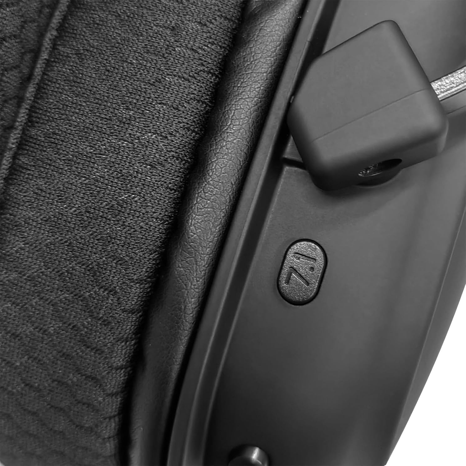 Close-up of 7.1 surround sound button on Redragon Zeus Pro wireless headset left ear cup and textured ear cushion